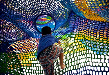 Child Climbing on Crochet Playground Landscape